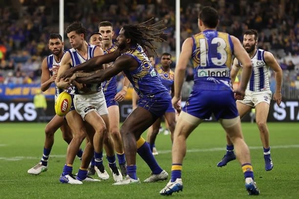 Jy Simpkin of the Kangaroos and Nic Naitanui of the Eagles contest for the ball during the round 17 AFL match between the West Coast Eagles and North...