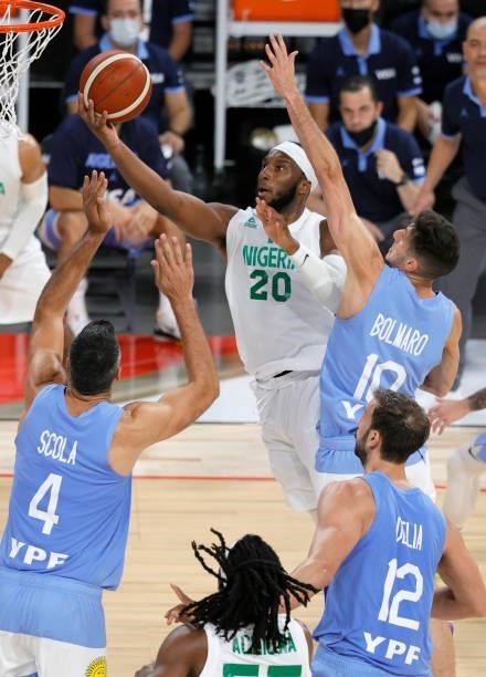 Josh Okogie of Nigeria drives to the basket against Luis Scola, Leandro Bolmaro and Marcos Delia of Argentina during an exhibition game at Michelob...