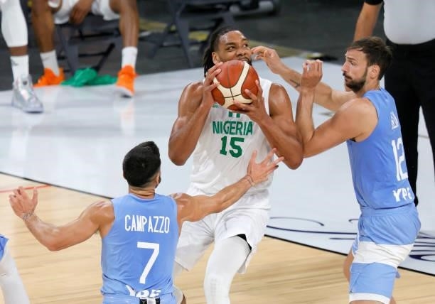 Jahlil Okafor of Nigeria is defended by Facundo Campazzo and Marcos Delia of Argentina during an exhibition game at Michelob ULTRA Arena ahead of the...