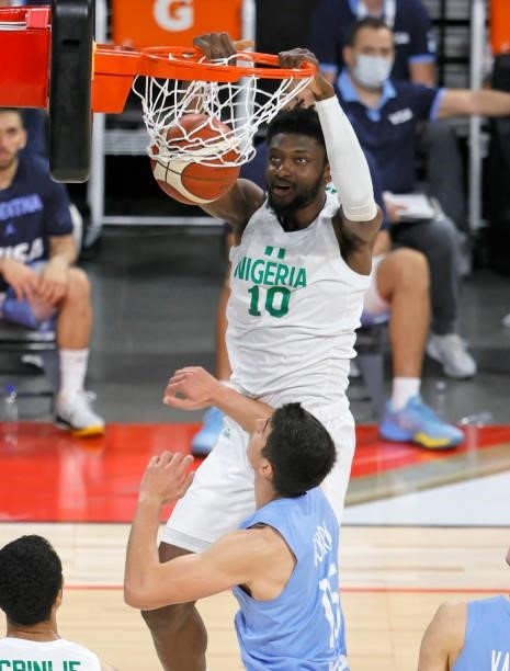 Chimezie Metu of Nigeria dunks over Lautaro Berra of Argentina during an exhibition game at Michelob ULTRA Arena ahead of the Tokyo Olympic Games on...
