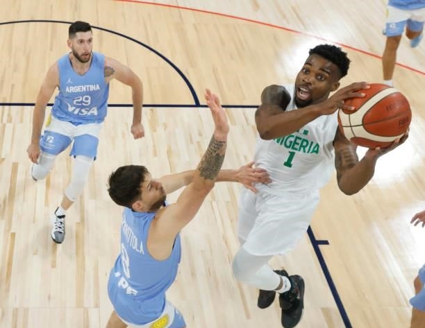 Ike Iroegbu of Nigeria drives to the basket against Nicolas Laprovittola of Argentina during an exhibition game at Michelob ULTRA Arena ahead of the...