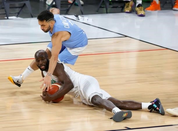 Facundo Campazzo of Argentina fouls Obi Emegano of Nigeria as he dives for a loose ball during an exhibition game at Michelob ULTRA Arena ahead of...