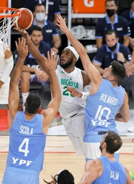 Josh Okogie of Nigeria drives to the basket against Luis Scola and Leandro Bolmaro of Argentina during an exhibition game at Michelob ULTRA Arena...