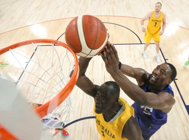 Duop Reath of the Australia Boomers and Bam Adebayo of the United States battle for a rebound during an exhibition game at Michelob Ultra Arena ahead...