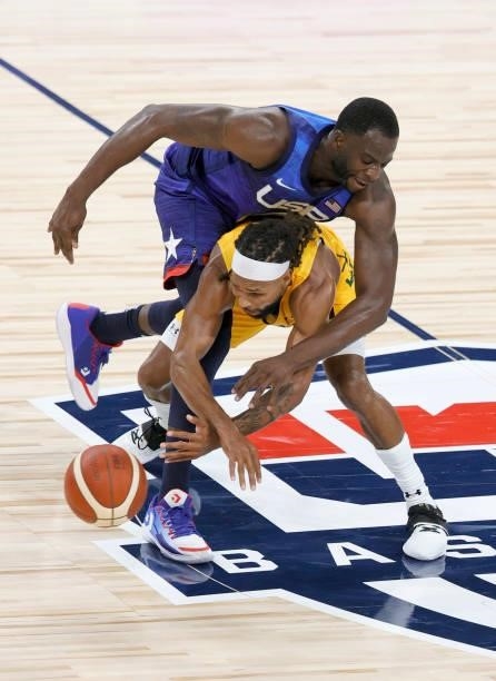 Draymond Green of the United States fouls Patty Mills of the Australia Boomers during an exhibition game at Michelob Ultra Arena ahead of the Tokyo...