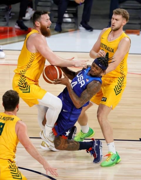 Bradley Beal of the United States drives into Aron Baynes of the Australia Boomers as Jock Landale of the Boomers defends during an exhibition game...