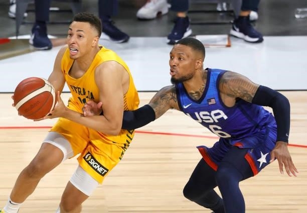 Dante Exum of the Australia Boomers drives against Damian Lillard of the United States during an exhibition game at Michelob Ultra Arena ahead of the...
