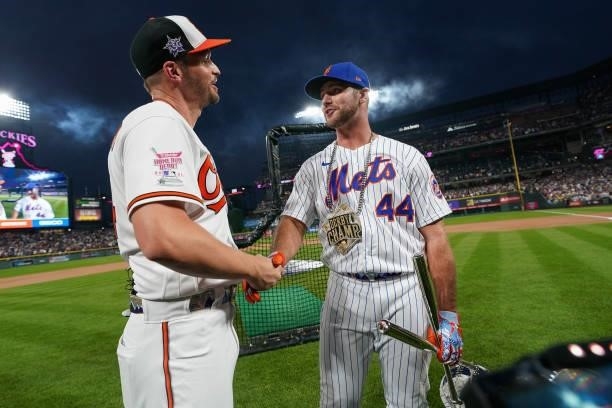 Trey Manchini of the Baltimore Orioles and Pete Alonso of the New York Mets shake hands after the 2021 T-Mobile Home Run Derby at Coors Field on July...