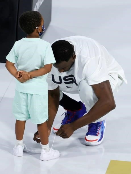 Draymond Green of the United States ties the shoes of his son Draymond Green Jr. Before an exhibition game against the Australia Boomers at Michelob...