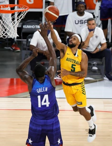 Patty Mills of the Australia Boomers drives to the basket against Draymond Green of the United States during an exhibition game at Michelob Ultra...