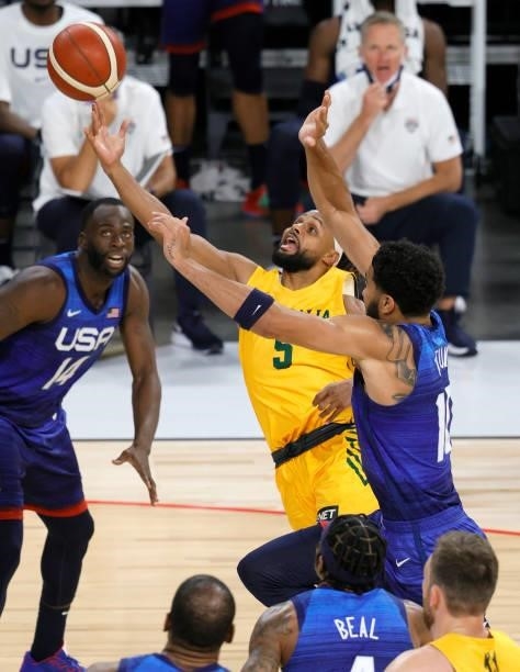 Patty Mills of the Australia Boomers drives to the basket against Jayson Tatum of the United States during an exhibition game at Michelob Ultra Arena...