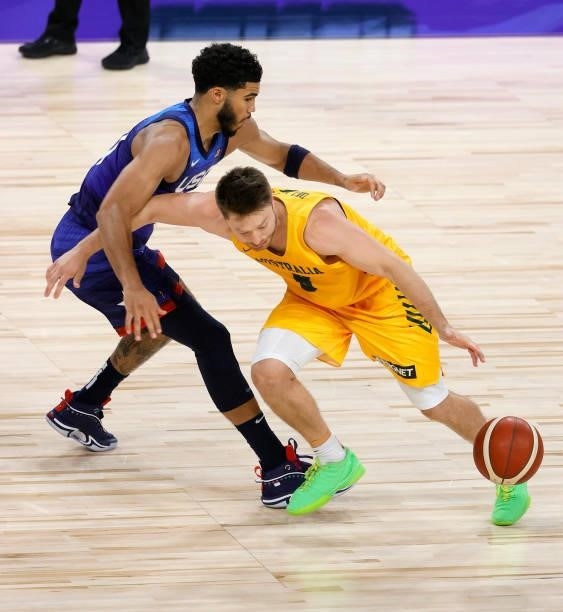 Jayson Tatum of the United States knocks the ball away from Matthew Dellavedova of the Australia Boomers during an exhibition game at Michelob Ultra...