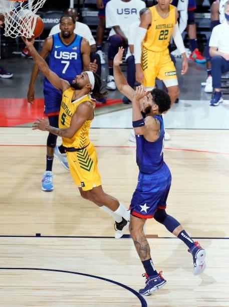 Patty Mills of the Australia Boomers drives to the basket against Jayson Tatum of the United States during an exhibition game at Michelob Ultra Arena...