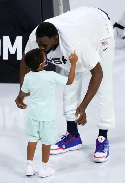Draymond Green of the United States kisses his son Draymond Green Jr. Before an exhibition game against the Australia Boomers at Michelob Ultra Arena...