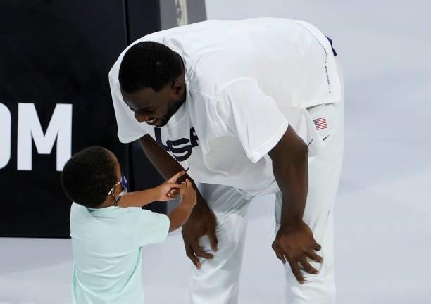 Draymond Green of the United States talks with his son Draymond Green Jr. Before an exhibition game against the Australia Boomers at Michelob Ultra...