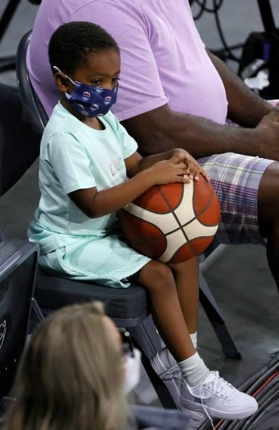 Draymond Green Jr., son of Draymond Green of the United States, holds a basketball as he waits for his father's exhibition game against the Australia...