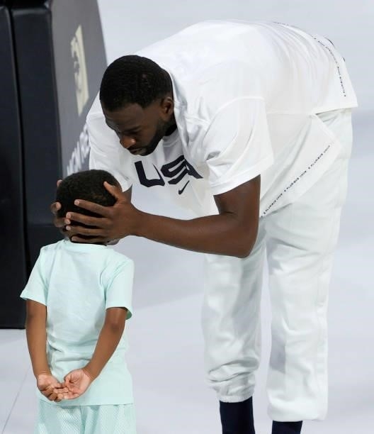 Draymond Green of the United States hugs his son Draymond Green Jr. Before an exhibition game against the Australia Boomers at Michelob Ultra Arena...