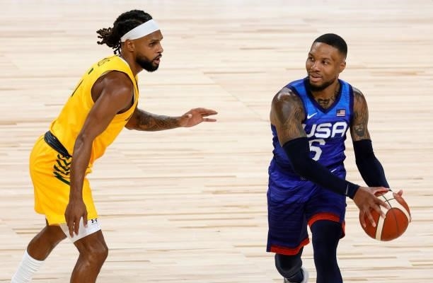Damian Lillard of the United States is guarded by Patty Mills of the Australia Boomers during an exhibition game at Michelob Ultra Arena ahead of the...