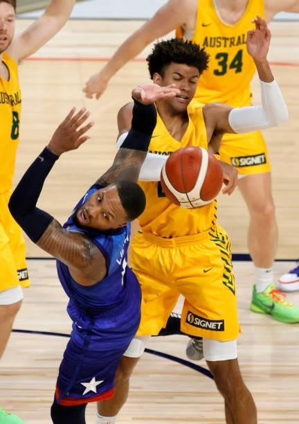 Matisse Thybulle of the Australia Boomers blocks a shot by Damian Lillard of the United States during an exhibition game at Michelob Ultra Arena...