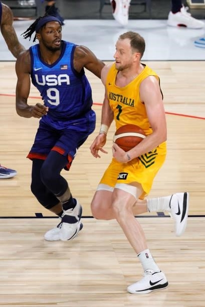 Joe Ingles of the Australia Boomers drives against Jerami Grant of the United States during an exhibition game at Michelob Ultra Arena ahead of the...