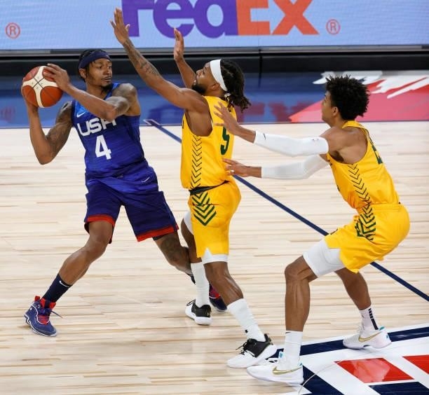 Bradley Beal of the United States is guarded by Patty Mills and Matisse Thybulle of the Australia Boomers during an exhibition game at Michelob Ultra...