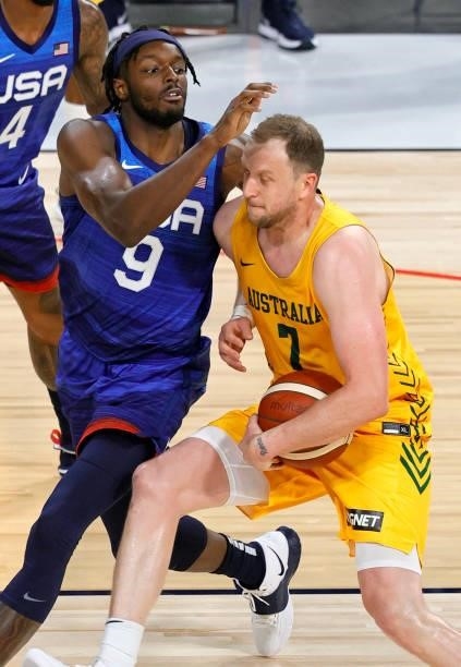 Joe Ingles of the Australia Boomers drives against Jerami Grant of the United States during an exhibition game at Michelob Ultra Arena ahead of the...