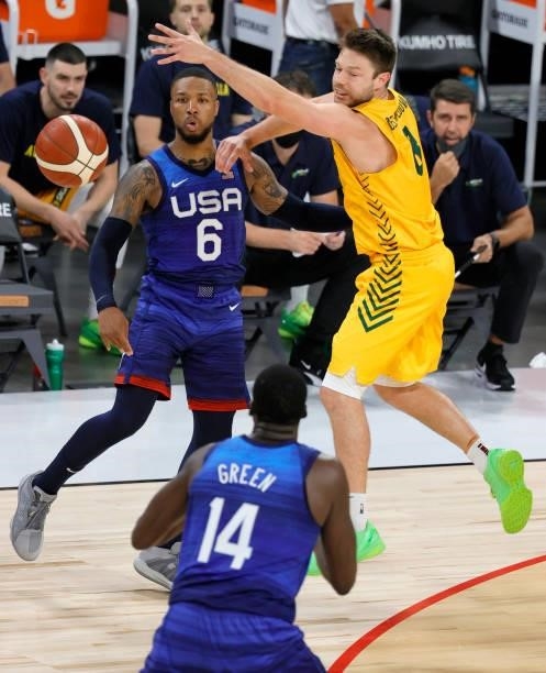 Damian Lillard of the United States passes to teammate Draymond Green as Matthew Dellavedova of the Australia Boomers defends during an exhibition...