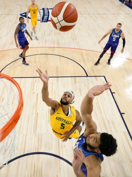 Patty Mills of the Australia Boomers shoots a layup against Jayson Tatum of the United States during an exhibition game at Michelob Ultra Arena ahead...