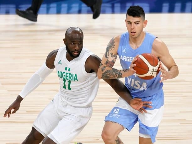 Gabriel Deck of Argentina passes under pressure from Obi Emegano of Nigeria during an exhibition game at Michelob ULTRA Arena ahead of the Tokyo...