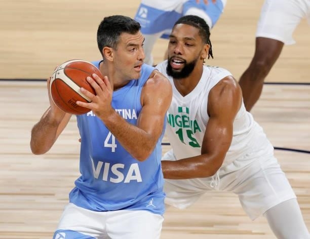 Luis Scola of Argentina is guarded by Jahlil Okafor of Nigeria during an exhibition game at Michelob ULTRA Arena ahead of the Tokyo Olympic Games on...