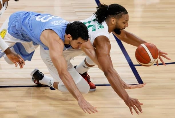 Tayavek Gallizzi of Argentina and Jahlil Okafor of Nigeria go after a loose ball during an exhibition game at Michelob ULTRA Arena ahead of the Tokyo...