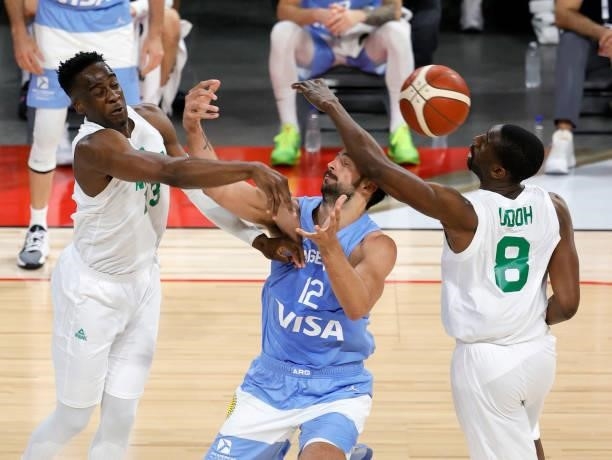 Miye Oni of Nigeria knocks the ball away from Marcos Delia of Argentina as Ekpe Udoh of Nigeria defends during an exhibition game at Michelob ULTRA...