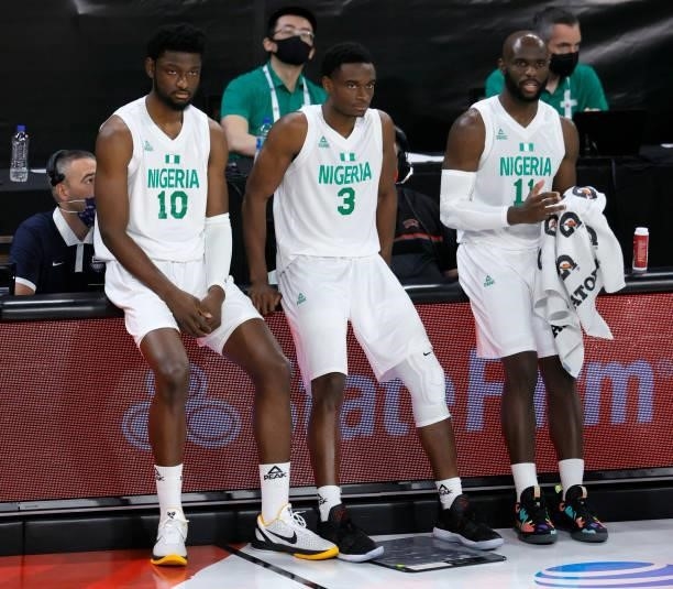 Chimezie Metu, Caleb Agada and Obi Emegano of Nigeria wait to check in during an exhibition game against Argentina at Michelob ULTRA Arena ahead of...