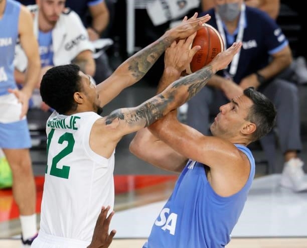 Michael Gbinije of Nigeria blocks a shot by Luis Scola of Argentina during an exhibition game at Michelob ULTRA Arena ahead of the Tokyo Olympic...