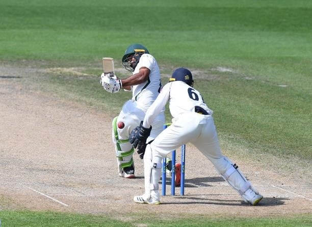 Ish Sodhi of Worcestershire hits his shot past Michael Burgess of Warwickshire during the LV = Insurance County Championship match between...