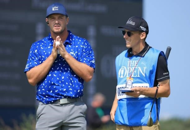 Bryson Dechambeau of The United States looks on with his caddie during a practice round for The 149th Open at Royal St George’s Golf Club on July 13,...