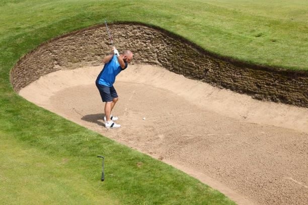 Andy Sullivan of England of England plays a shot from a bunker during a practice round for The 149th Open at Royal St George’s Golf Club on July 13,...