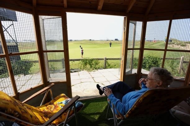 Spectator looks onto course from their garden during a practice round for The 149th Open at Royal St George’s Golf Club on July 13, 2021 in Sandwich,...