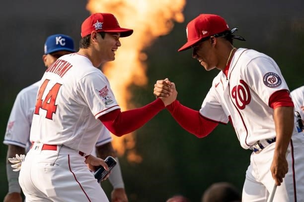 Shohei Ohtani of the Los Angeles Angels shakes hands with Juan Soto of the Washington Nationals during the 2021 T-Mobile Home Run Derby at Coors...