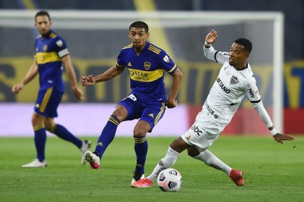 Cristian Medina of Boca Juniors fights for the ball with Jefferson Savarino of Atletico MG during a round of sixteen match between Boca Juniors and...