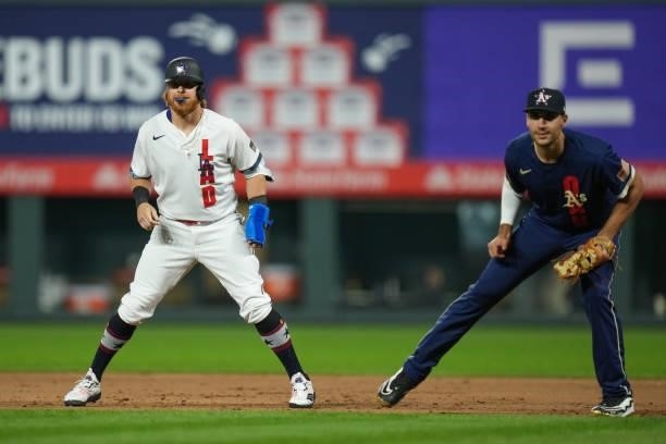 National League All-Star Justin Turner of the Los Angeles Dodgers leads off first base ahead of American League All-Star Matt Olson of the Oakland...