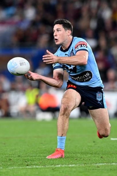Mitchell Moses of the Blues offloads the ball during game three of the 2021 State of Origin Series between the New South Wales Blues and the...