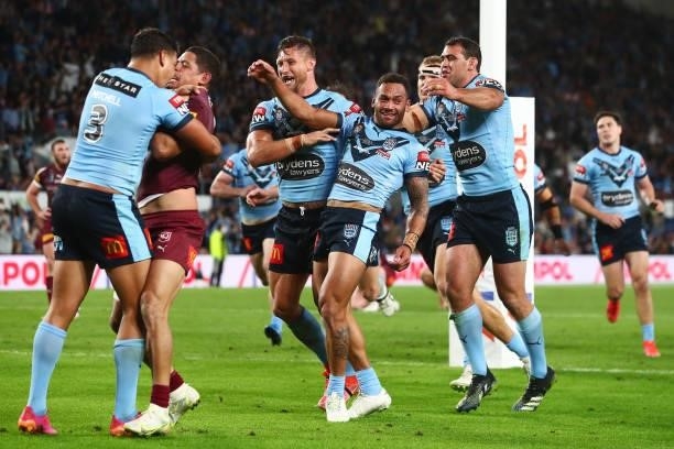 Api Koroisau of the Blues celebrates with team mates after scoring a try as Latrell Mitchell of the Blues wrestles with Dane Gagai of the Maroons...