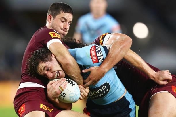 Cameron Murray of the Blues is tackled during game three of the 2021 State of Origin Series between the New South Wales Blues and the Queensland...