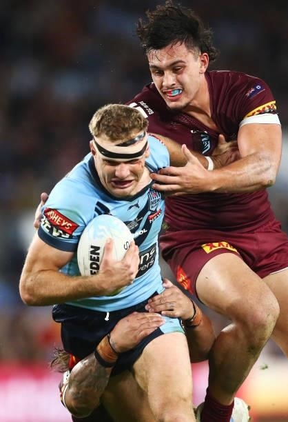 Tom Trbojevic of the Blues is tackled by Tino Fa'asuamaleaui of the Maroons during game three of the 2021 State of Origin Series between the New...
