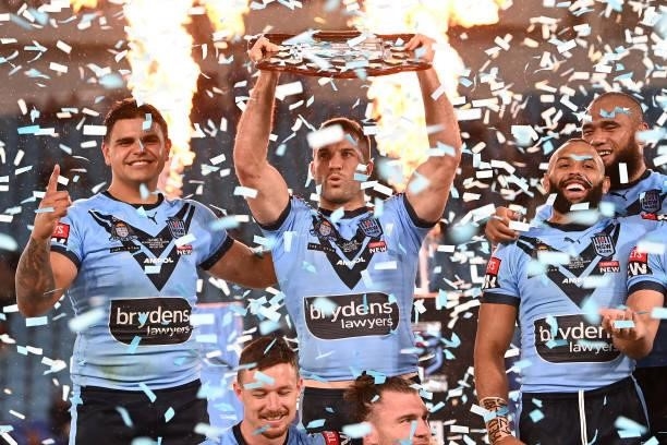 James Tedesco of the Blues holds aloft the Origin trophy after winning the series 2-1 after game three of the 2021 State of Origin Series between the...