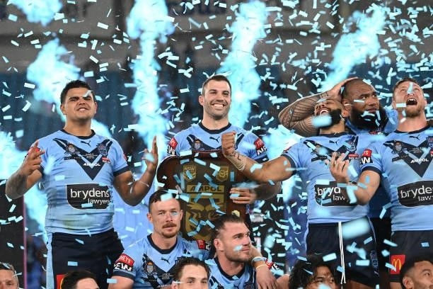 James Tedesco of the Blues holds aloft the Origin trophy after winning the series 2-1 after game three of the 2021 State of Origin Series between the...