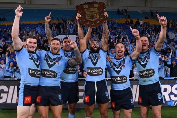 Josh Addo-Carr of the Blues holds aloft the Origin trophy and celebrates with team mates after winning the series 2-1 after game three of the 2021...