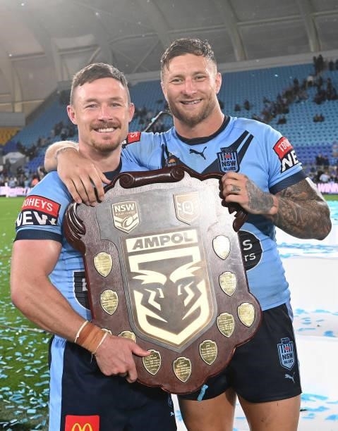 Damien Cook of the Blues and Tariq Sims of the Blues pose with the trophy after winning the series 2-1 after game three of the 2021 State of Origin...