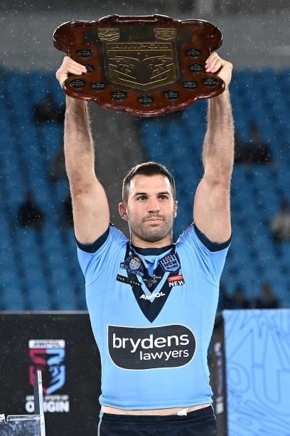 James Tedesco of the Blues holds aloft the Origin trophy and celebrates with team mates after winning the series 2-1 after game three of the 2021...